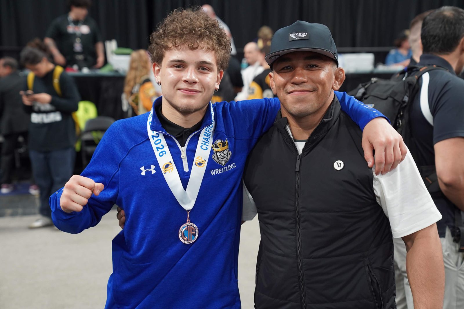 Coach Peyton Omania with one of his athletes at the CIF state championships